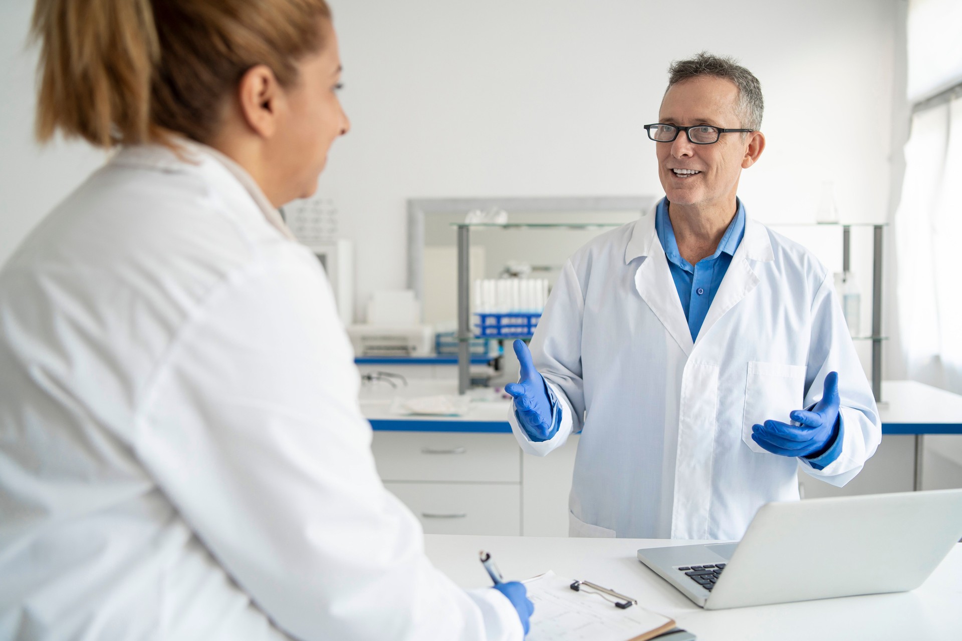 Male and female scientists collaborating on laboratory work